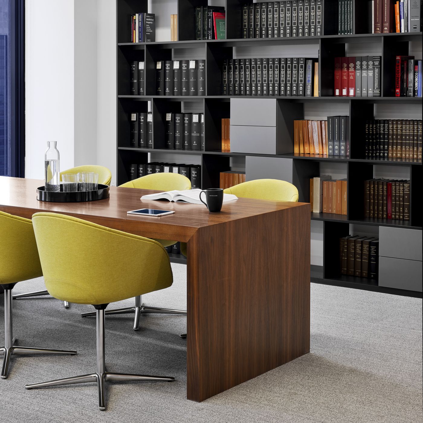 A beautiful Walnut HUGO table is the centerpiece of this meeting space.